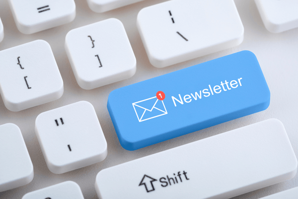 Keyboard with the word 'newsletters' written on the Return key